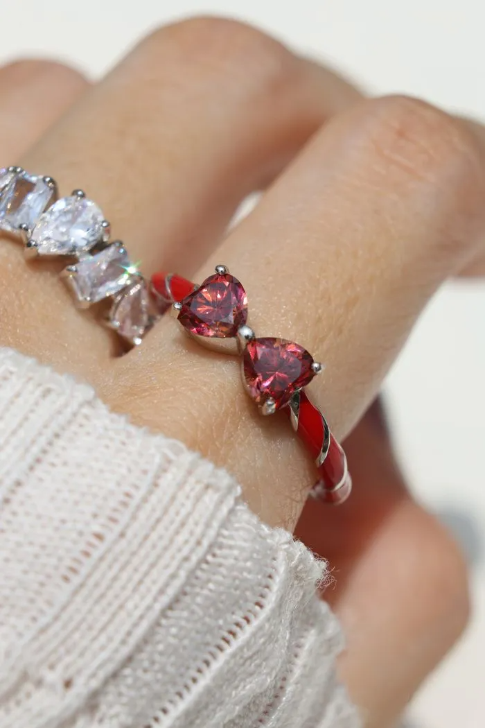 Candy Cane Ribbon Ring with heart-shaped red moissanite on finger