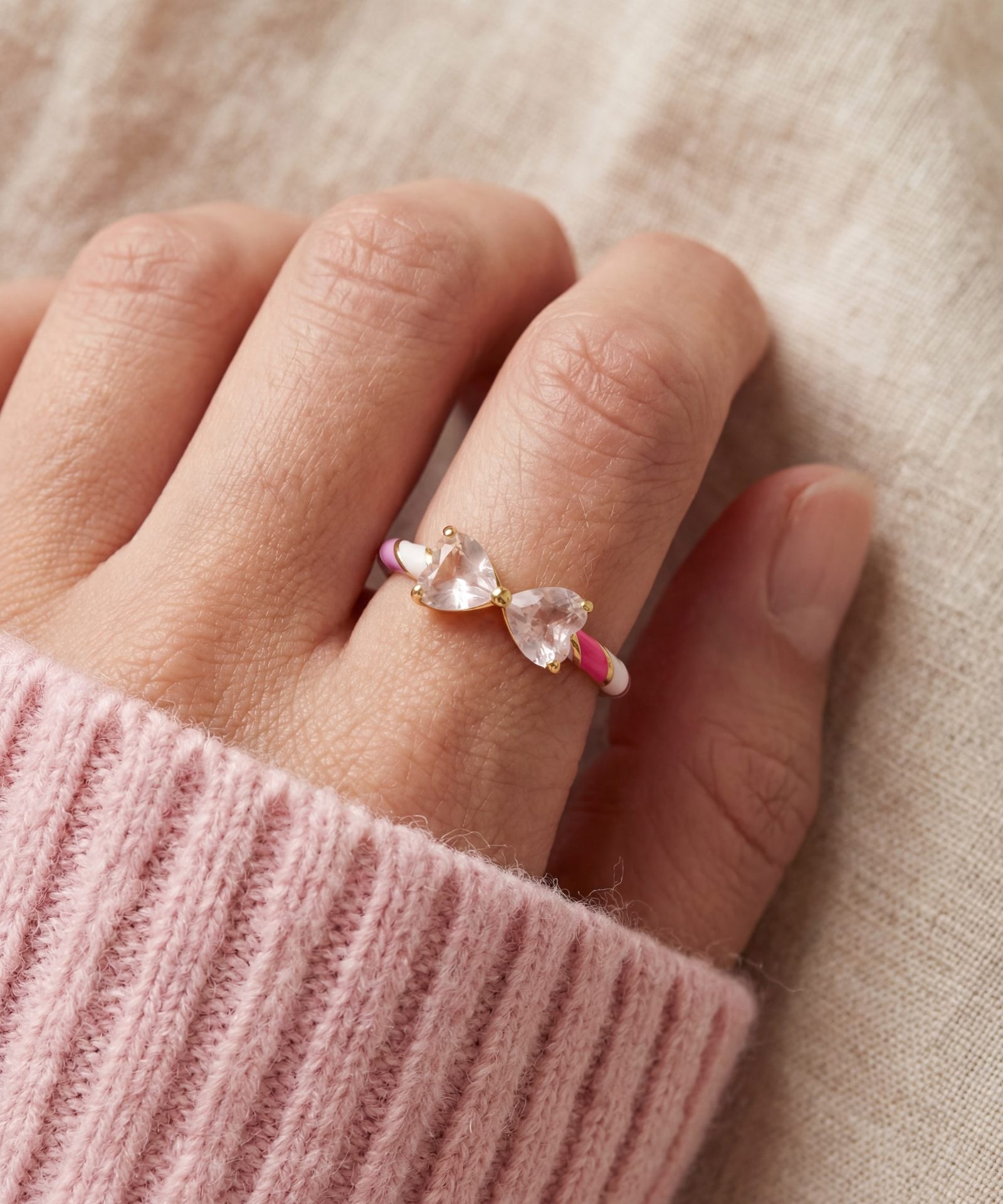 Candy Cane Ribbon Ring | Rose Quartz in yellow gold, worn on a model