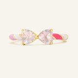 Close-up of the Candy Cane Ribbon Ring | Rose Quartz in yellow gold, resting on a warm linen background
