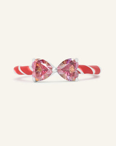 Close-up of the Candy Cane Ribbon Ring | Red Moissanite in silver, resting on a warm linen background