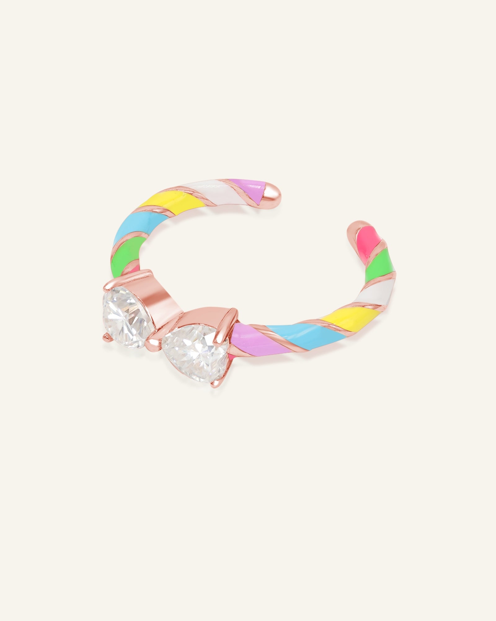 Candy Cane Ribbon Ring | White Moissanite in rose gold, resting on a warm linen background