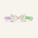 Candy Cane Ribbon Ring | White Moissanite in rose gold, resting on a warm linen background