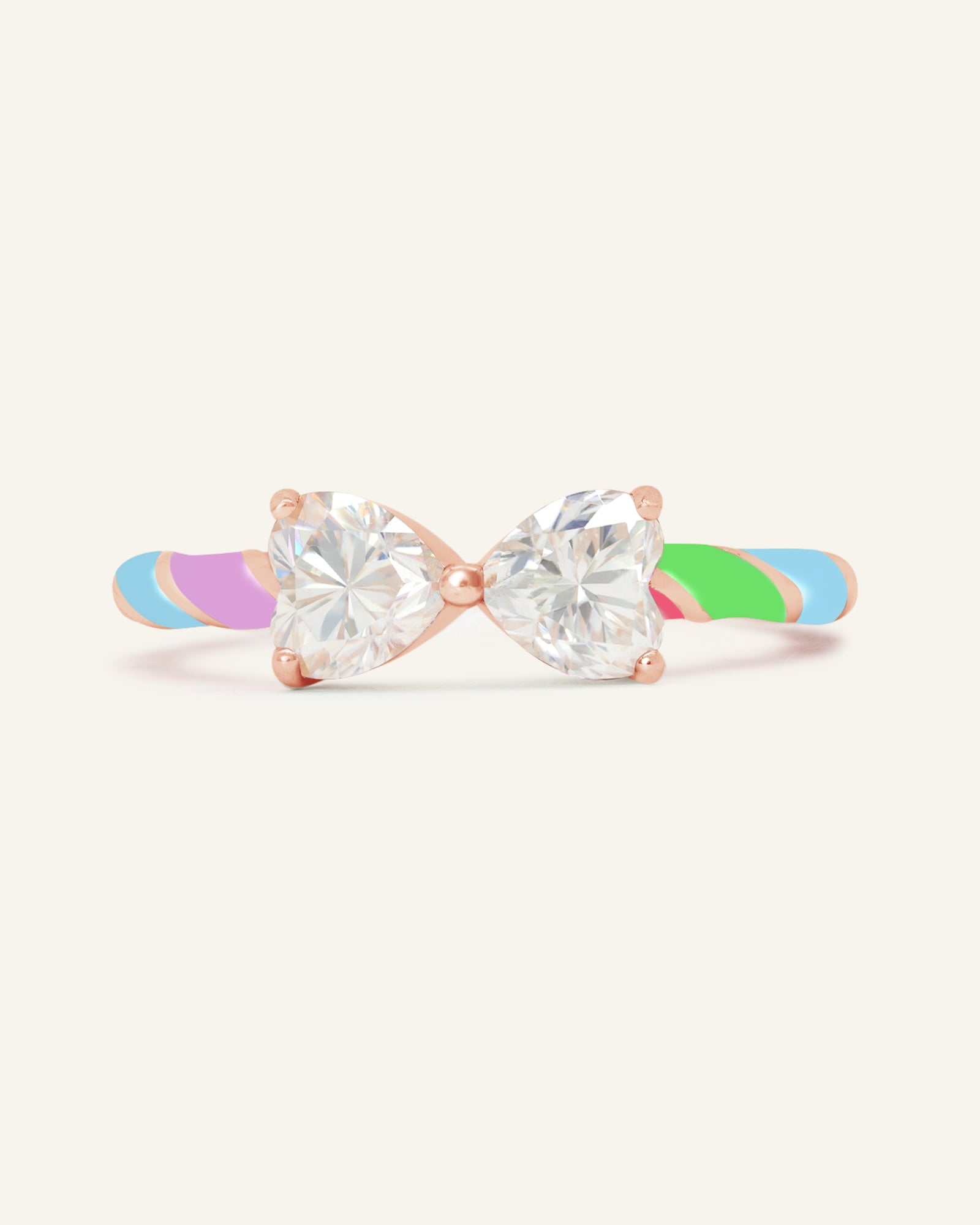 Candy Cane Ribbon Ring | White Moissanite in rose gold, resting on a warm linen background