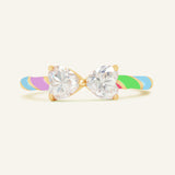 Close-up of the Candy Cane Ribbon Ring | White Moissanite in yellow gold, resting on a warm linen background