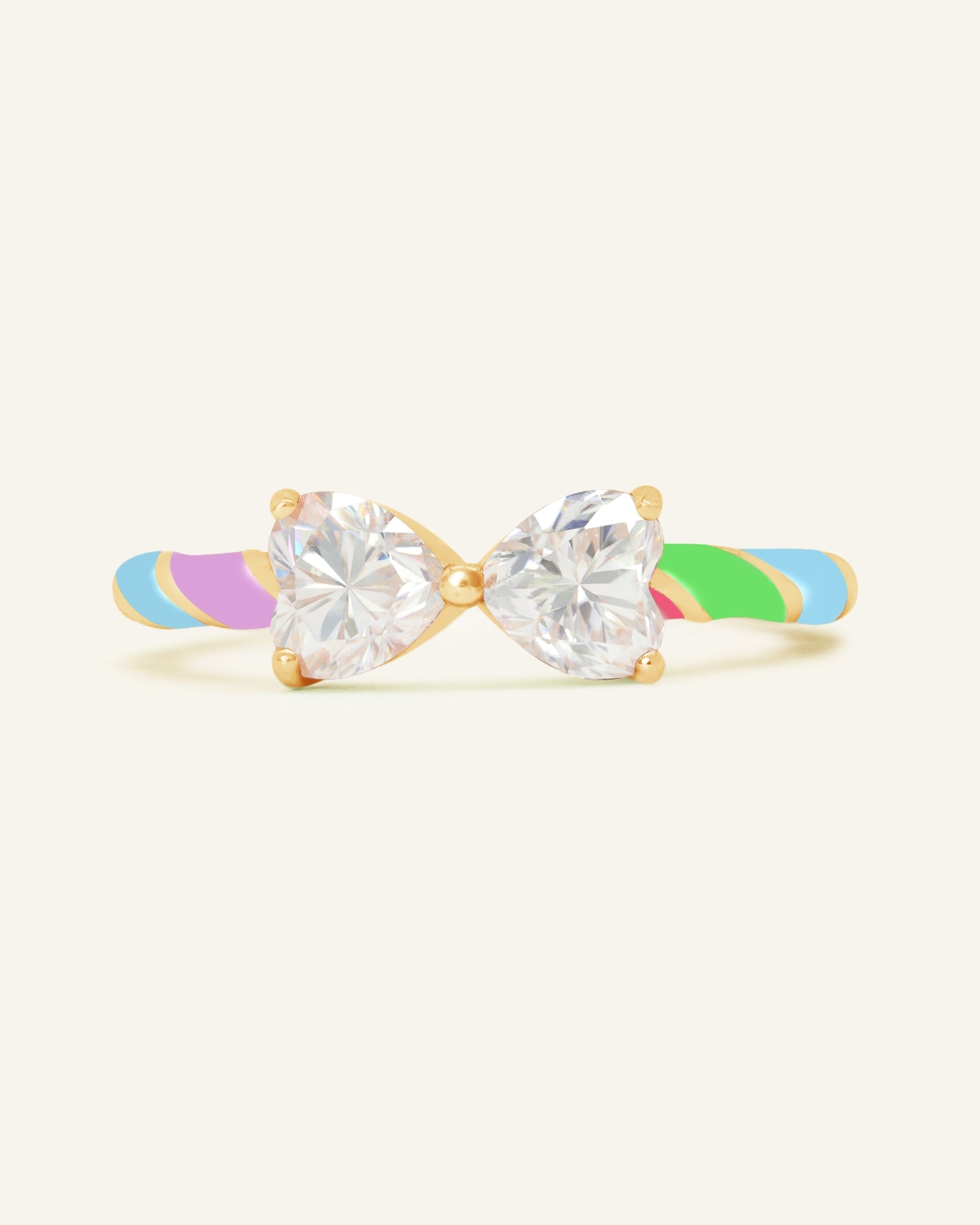 Close-up of the Candy Cane Ribbon Ring | White Moissanite in yellow gold, resting on a warm linen background