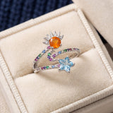 Celestial Harmony Ring | Orange Opal in silver, laid flat on a tabletop