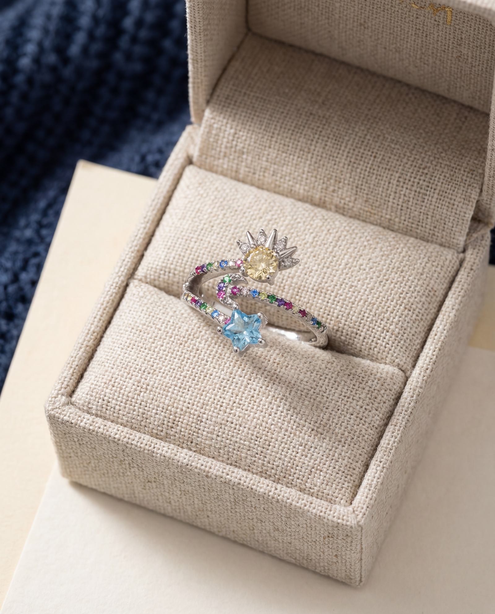 Celestial Harmony Ring | Yellow Moissanite in silver, laid flat on a tabletop