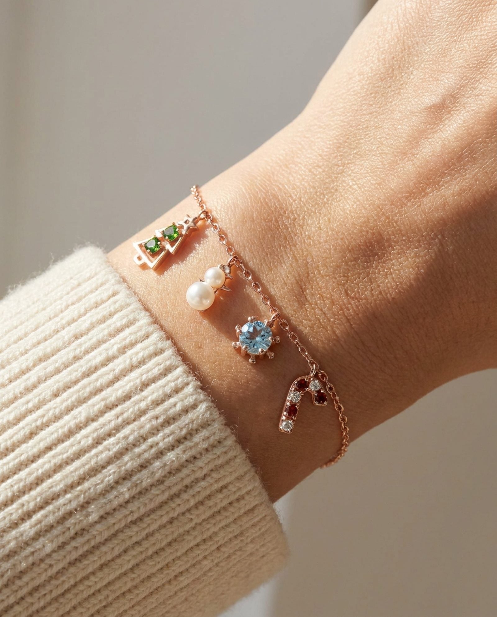Christmas Charm Bracelet in rose gold, worn on a model