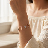 Christmas Charm Bracelet in rose gold, worn on a model