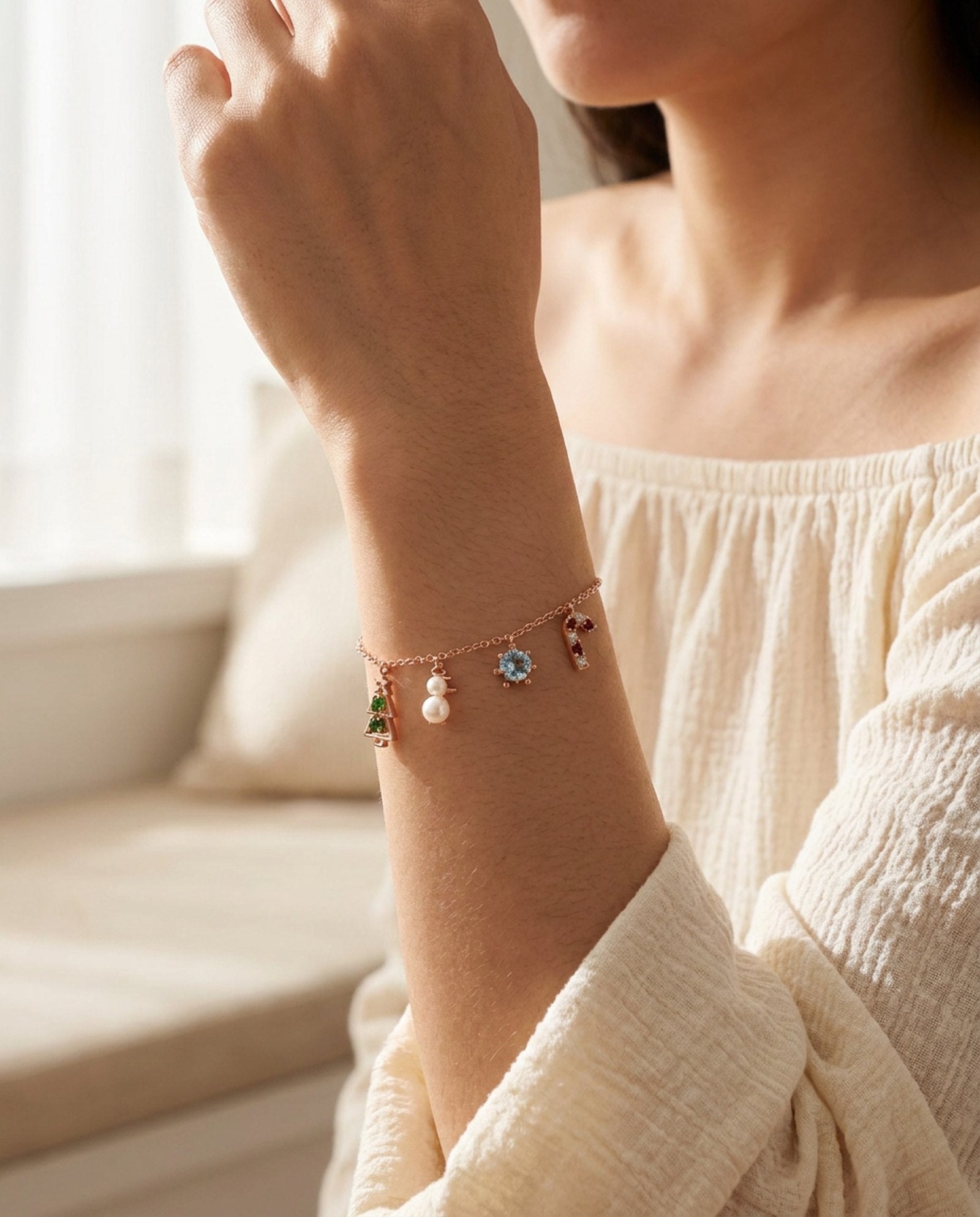 Christmas Charm Bracelet in rose gold, worn on a model