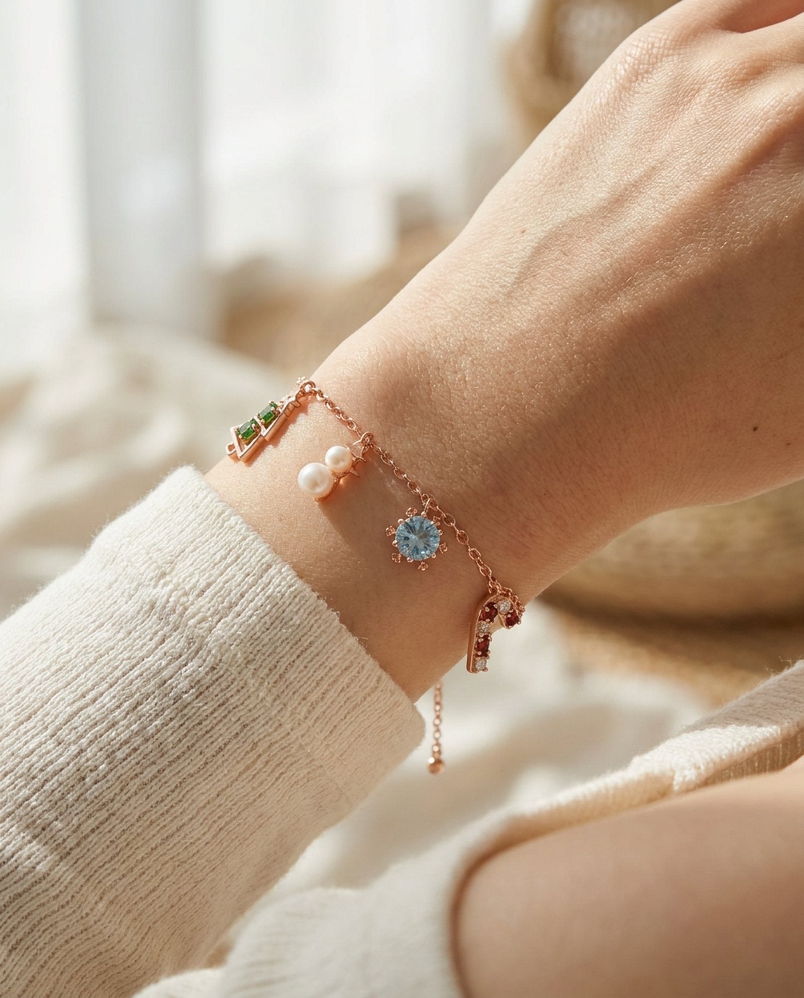 Christmas Charm Bracelet in rose gold, worn on a model