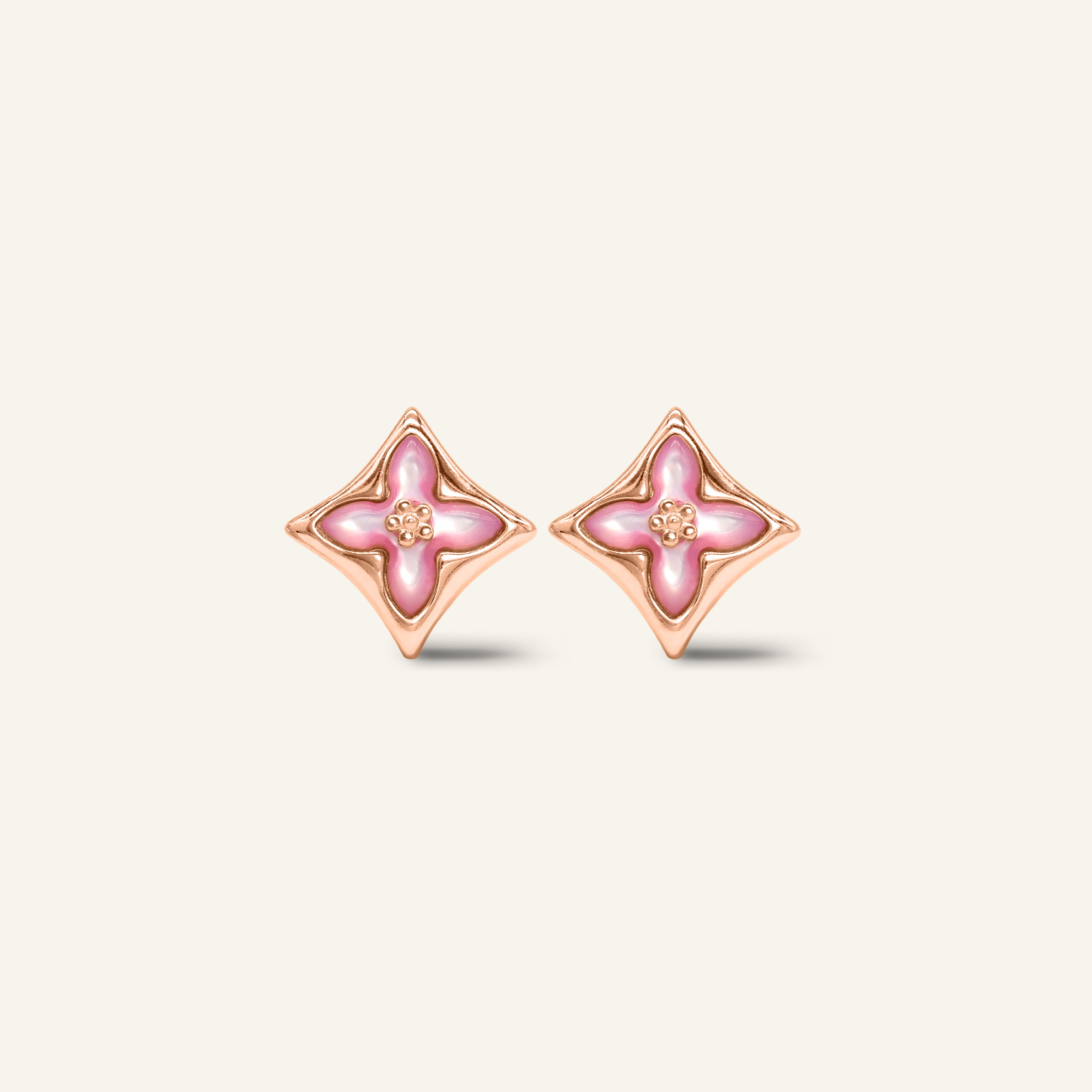 Close-up of a pair of rose gold clover monogram studs