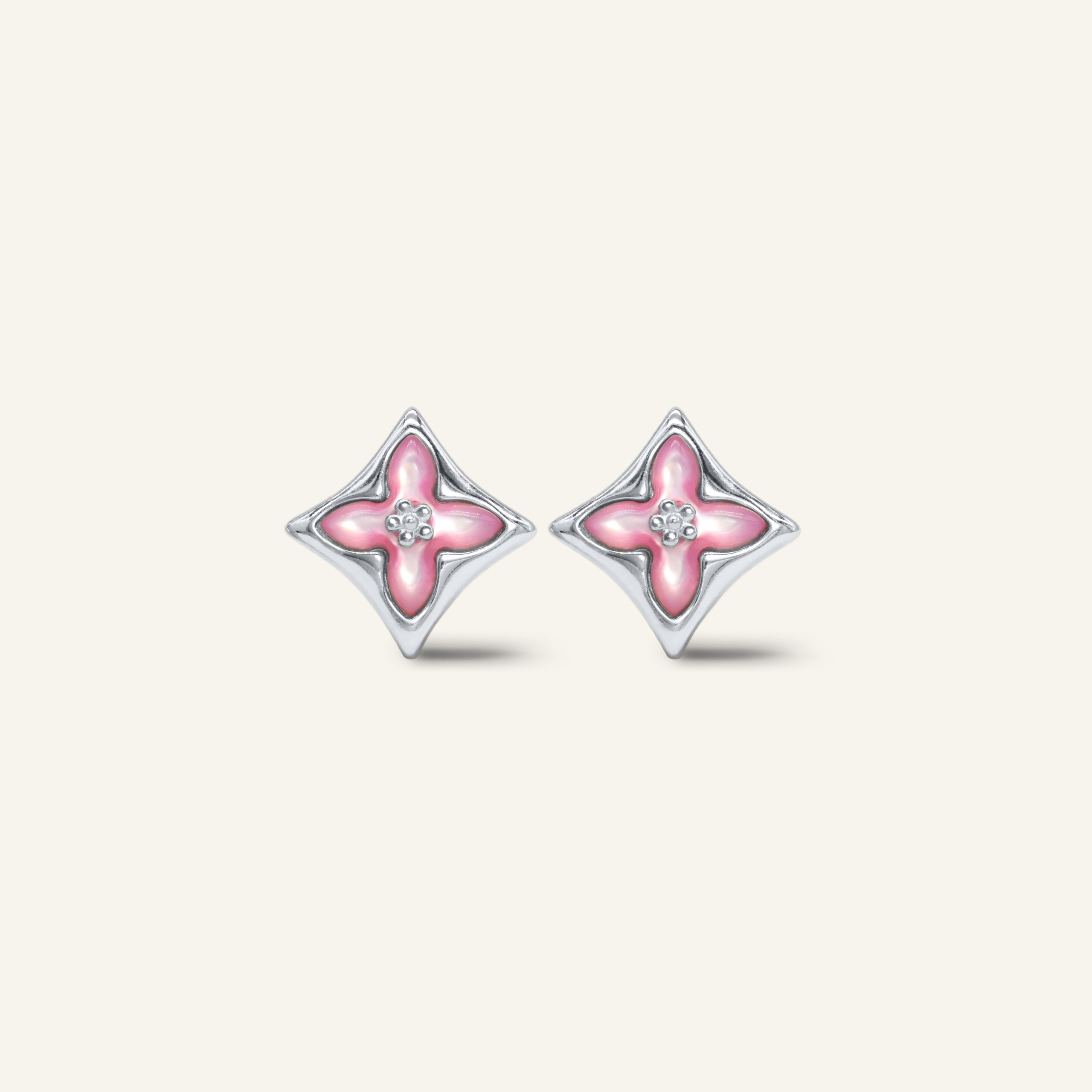 Close-up of a pair of silver clover monogram studs