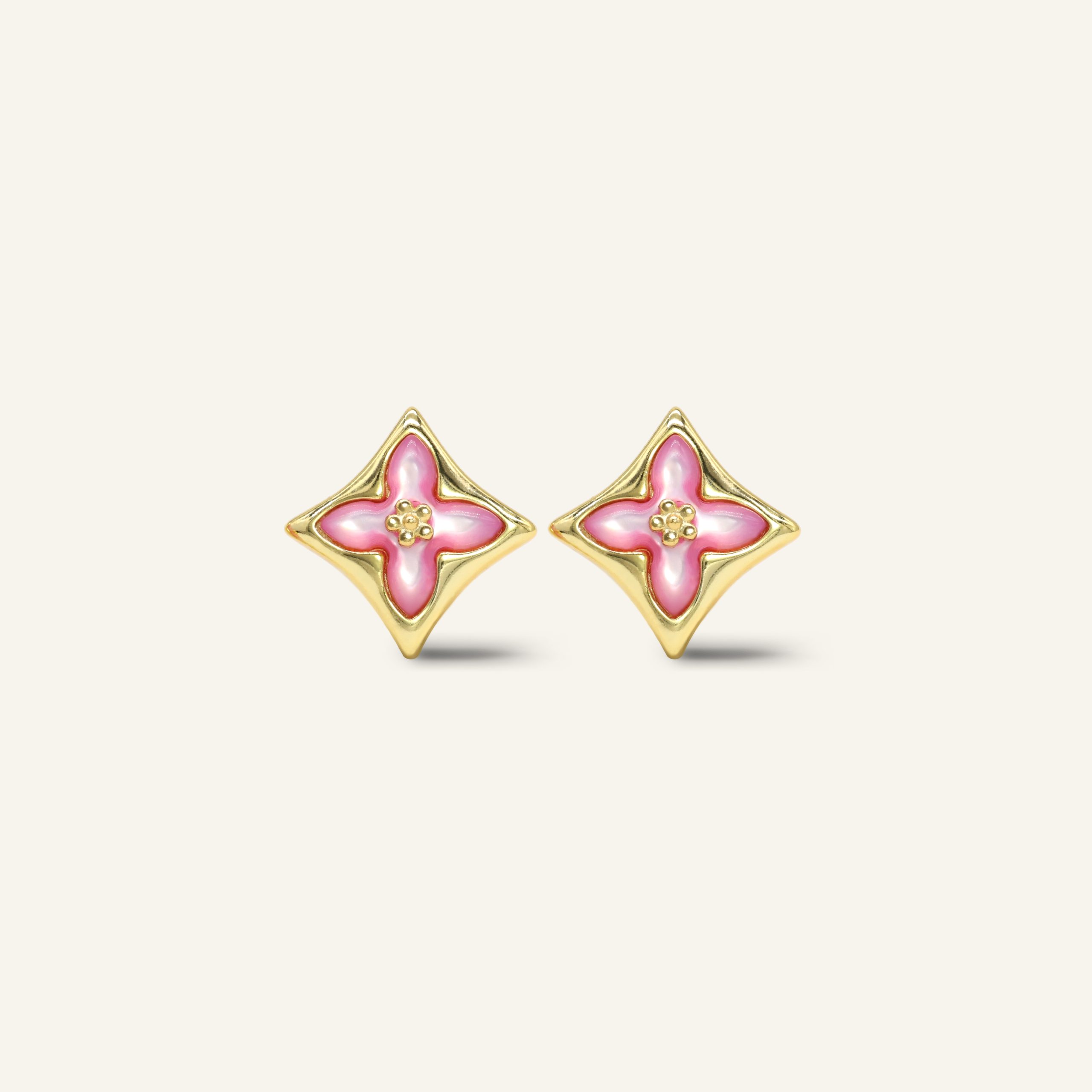 Close-up of a pair of yellow gold clover monogram studs