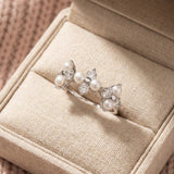 Trinity Clover Ring in silver, laid flat on a tabletop