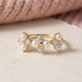 Trinity Clover Ring in yellow gold, laid flat on a tabletop