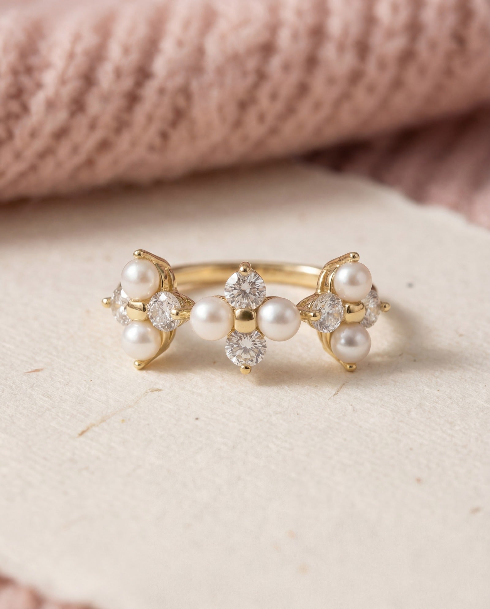 Trinity Clover Ring in yellow gold, laid flat on a tabletop