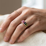 Hand showing a rose gold Color Burst Oval Ring stacked with a simple plain band and a twisted ring.