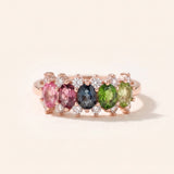 Symmetrical view of an 18k rose gold vermeil Color Burst Oval Ring displaying a natural gemstone gradient with halo accents.