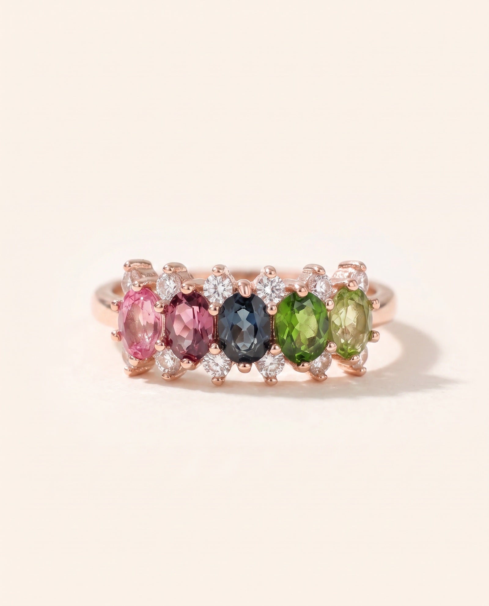 Symmetrical view of an 18k rose gold vermeil Color Burst Oval Ring displaying a natural gemstone gradient with halo accents.