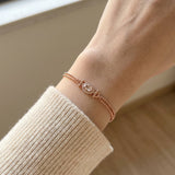 A close-up view of the rose gold Constance Petite Morganite Bracelet worn solo on a petite wrist, highlighting its elegant fit and the soft glow of the peach gemstone.