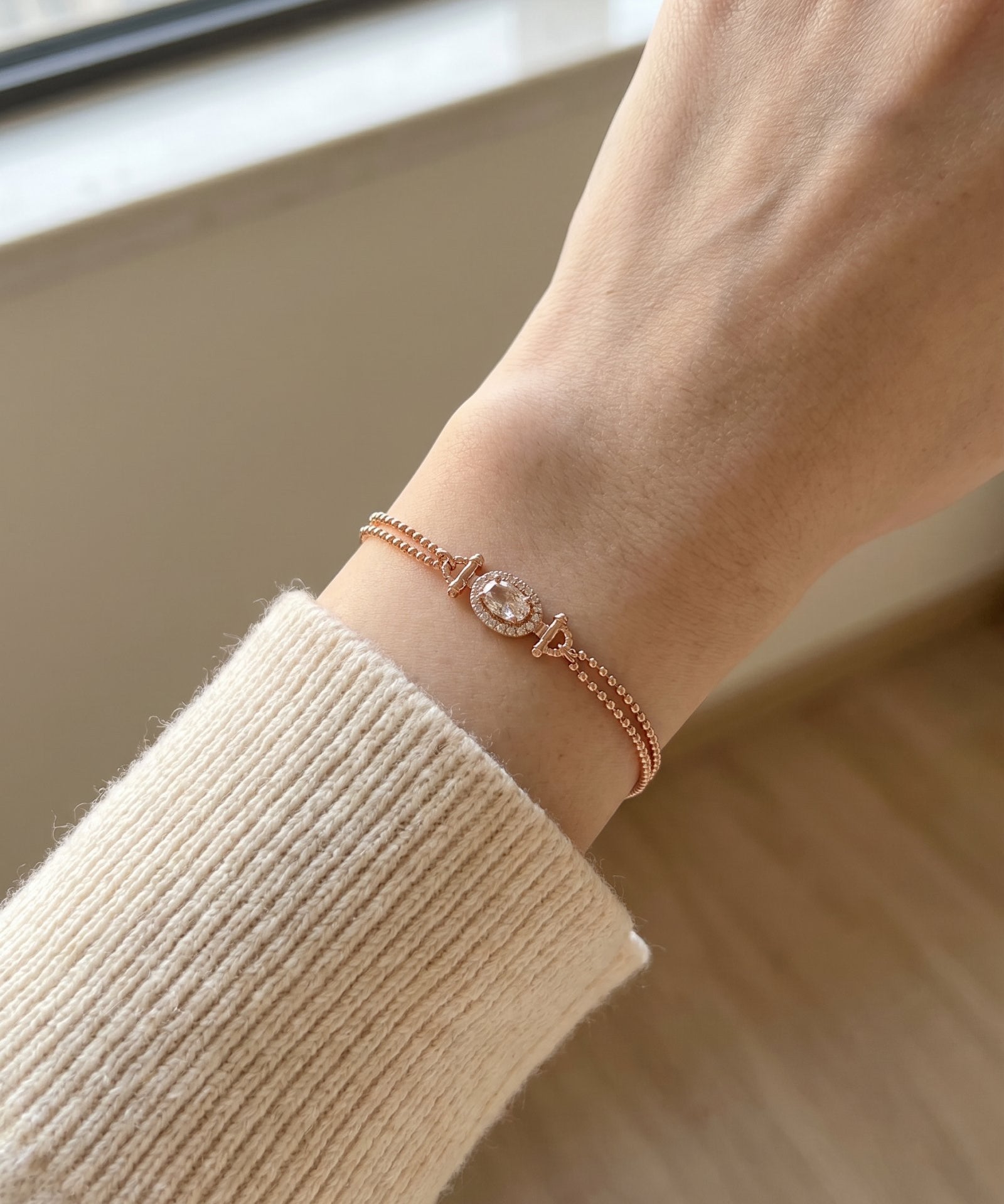 A close-up view of the rose gold Constance Petite Morganite Bracelet worn solo on a petite wrist, highlighting its elegant fit and the soft glow of the peach gemstone.