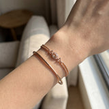 A lifestyle shot of the Constance Petite Morganite Bracelet in rose gold, styled effortlessly on a model to show the scale and brilliance of the oval halo design.