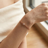 A model wearing the rose gold morganite bracelet, demonstrating the double-strand beaded chain's ability to provide a complete, textured look without the need for additional layering.