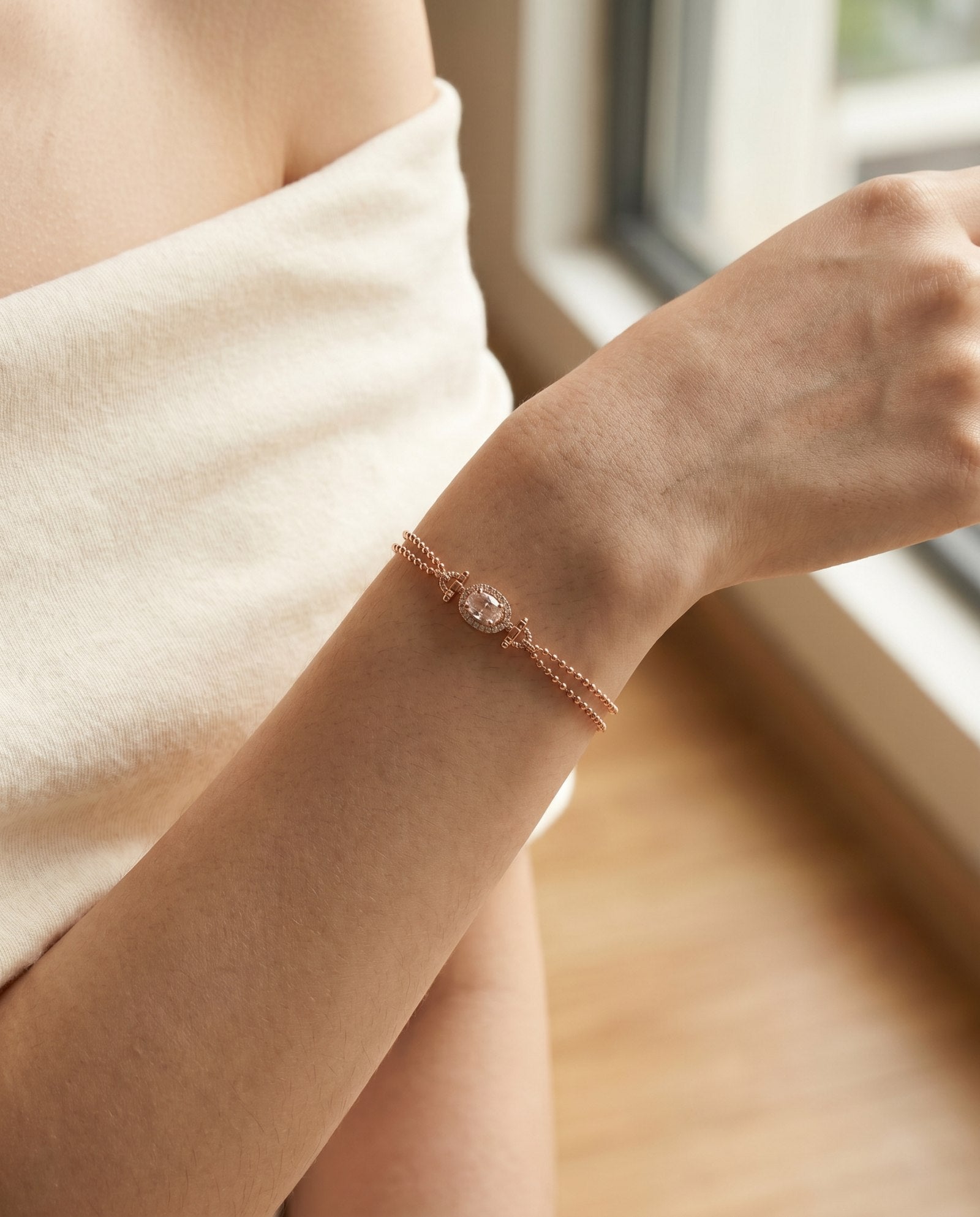A model wearing the rose gold morganite bracelet, demonstrating the double-strand beaded chain's ability to provide a complete, textured look without the need for additional layering.