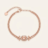 A studio product image of the Constance Petite Morganite Bracelet in rose gold, showcasing the natural peach-pink gemstone and the delicate heart charm at the end of the extension chain.