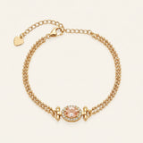 A top-down studio shot of the Constance Petite Morganite Bracelet in yellow gold, featuring a double-strand beaded chain and a peach morganite centerpiece with an oval halo.