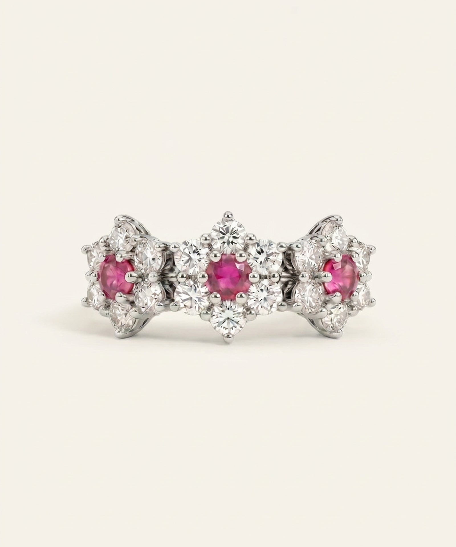 Coquette Bloom Ring in rhodium-plated silver with natural pink sapphires and shimmering white gemstone halos.
