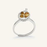 Durian Citrine Ring in silver, resting on a warm linen background