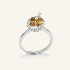 Durian Citrine Ring in silver, resting on a warm linen background