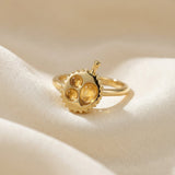 Durian Citrine Ring in yellow gold, laid flat on a tabletop