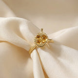 Durian Citrine Ring in yellow gold, laid flat on a tabletop