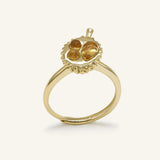 Close-up of the Durian Citrine Ring in yellow gold, resting on a warm linen background