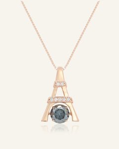 Close-up of the Eiffel Tower Moissanite Necklace in rose gold, resting on a warm linen background