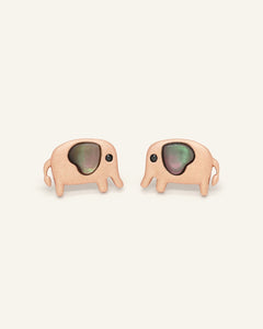 Close-up of the Elephant Mother of Pearl Studs | Black in rose gold, resting on a warm linen background