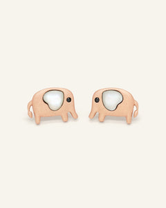 Close-up of the Elephant Mother of Pearl Studs | White in rose gold, resting on a warm linen background
