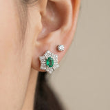 Direct on-ear view of the silver Emerald Starflower Studs, showcasing the clear, deep green of the natural Zambian emerald.