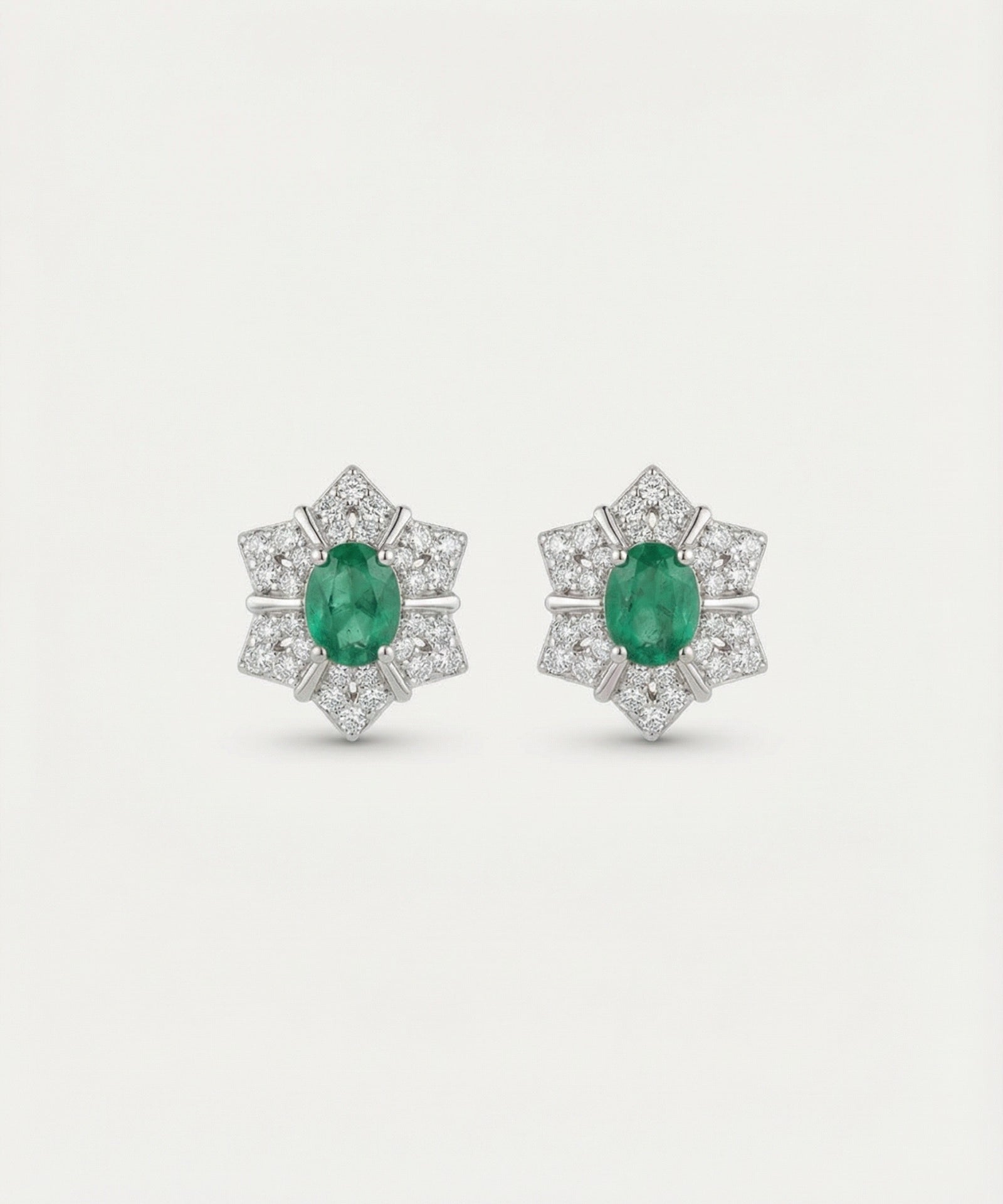 Main product image of the Emerald Starflower Studs in silver, featuring a geometric star-shaped halo.