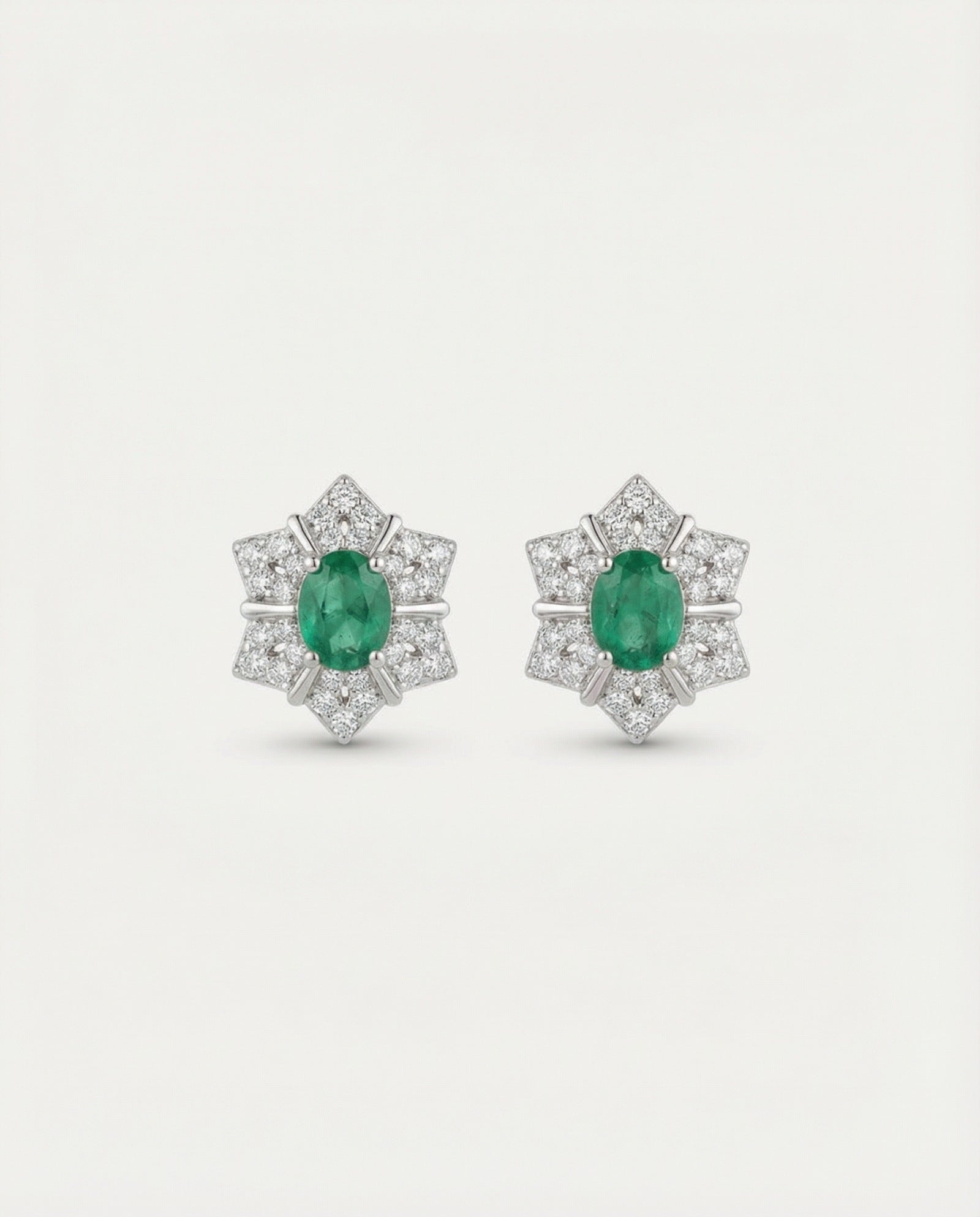 Main product image of the Emerald Starflower Studs in silver, featuring a geometric star-shaped halo.