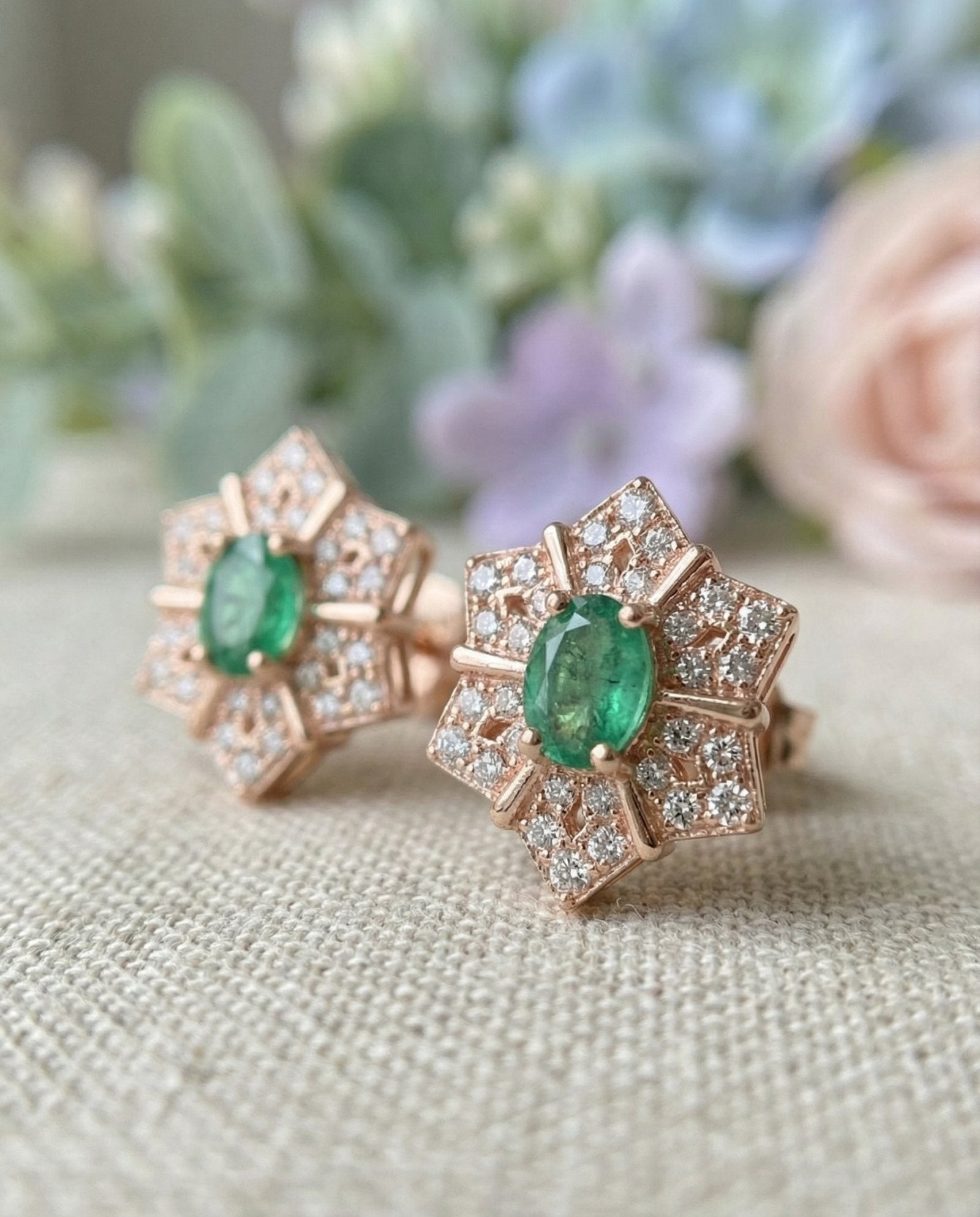 Macro photograph of the rose gold starflower earrings, showing the intricate pavé detailing and oval-cut emerald.