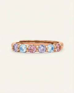 Entwine Eternity Band | Marshmellow, Elate in rose gold, resting on a warm linen background