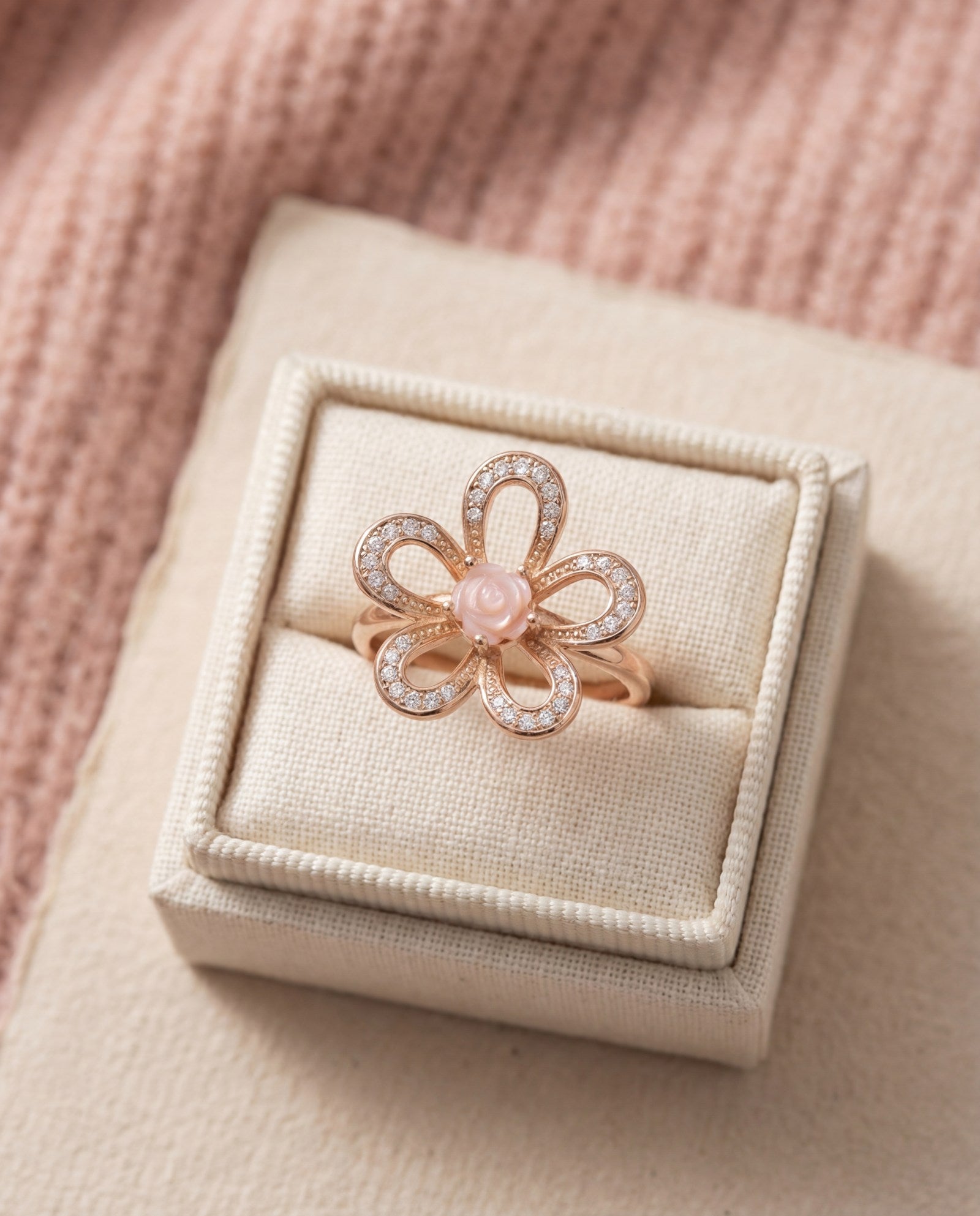Eternal Rose Shell Ring in rose gold, laid flat on a tabletop