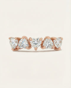 Eternity Heart Band | White, Elate in rose gold, resting on a warm linen background