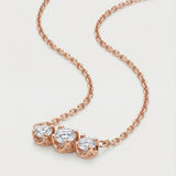 A professional product shot of the rose gold Everglow Trilogy Necklace, showcasing the fluid drape of the adjustable cable chain.