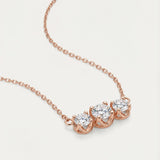 High-detail side view of the Everglow Trilogy Necklace in rose gold, showing the secure prong settings and fine-link cable chain.