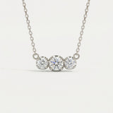 Product image of the Everglow Trilogy Moissanite Necklace in silver, highlighting the D-color VVS1 clarity of the stones.